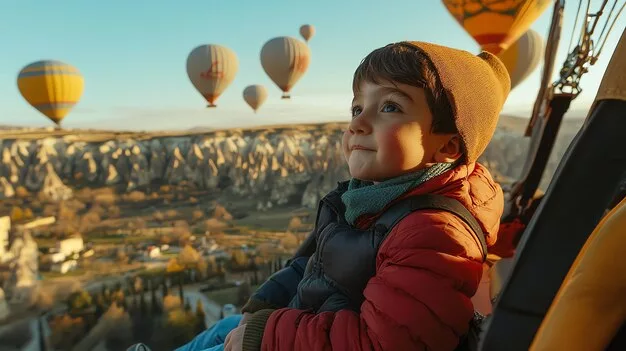 nino-mira-paisaje-globos-aire-caliente